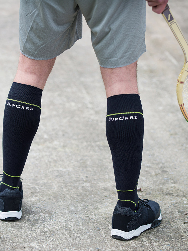 Sports compression socks with DriRelease®, black with green details