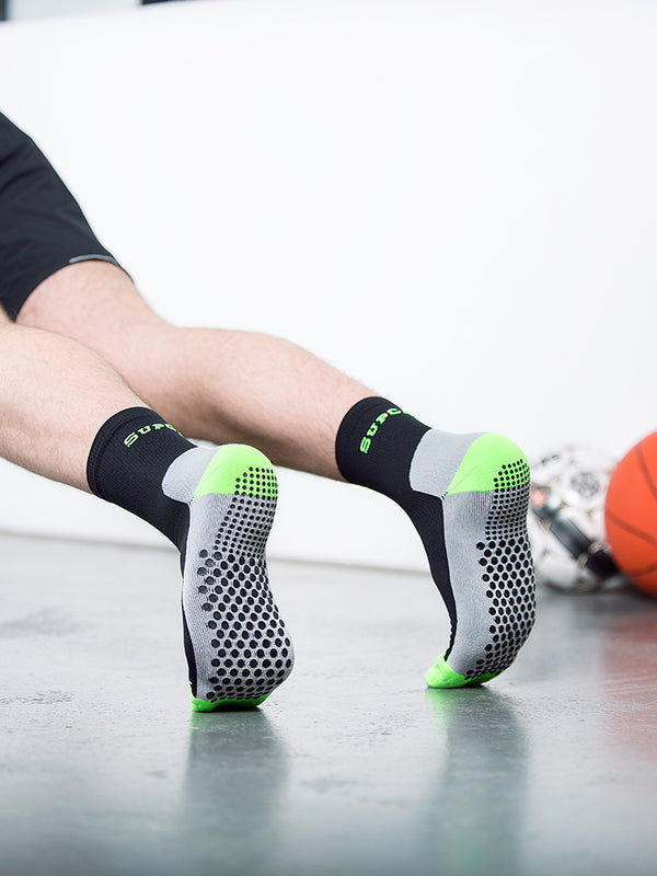 Sports compression crew socks with grip sole, black and neon green