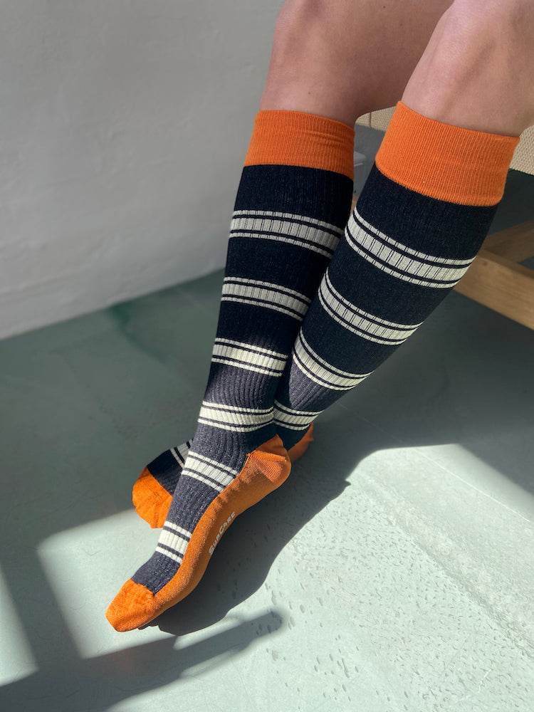 Bamboo compression stockings, black rib weave with orange and white stripes